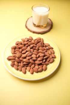 almond nut and milk on table top down.