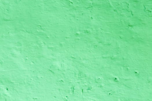 Green Textured Wall Background. The surface of the old plaster of green bright color.