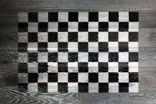 A Chequered flag on rustic old wood surface background