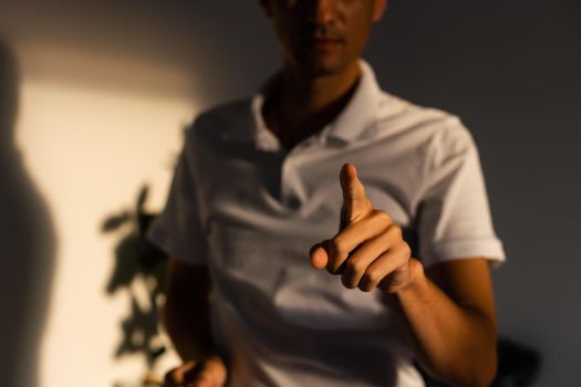 Young handsome man wearing casual t-shirt presenting with hand and pointing with finger