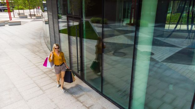 Happy woman shopping for clothes.