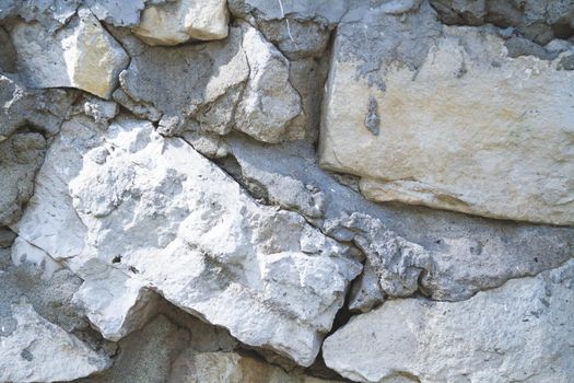 Texture of old stone. Old wall with a crack.Grunge background in dark color.