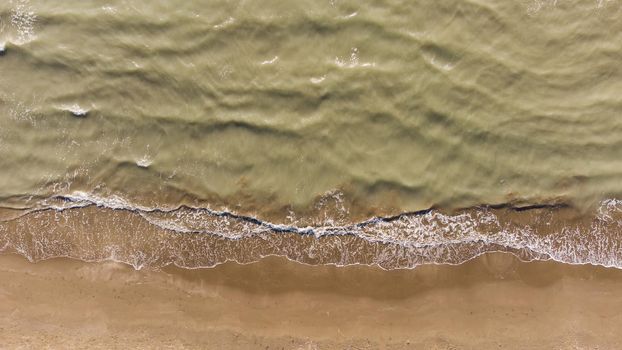 Soft wave of the sea on the sandy beach.