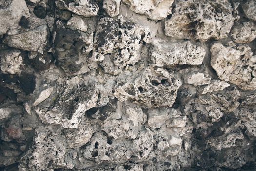 Texture of an old stone with a crack. Grunge brick texture. Old wall with cracked plaster.