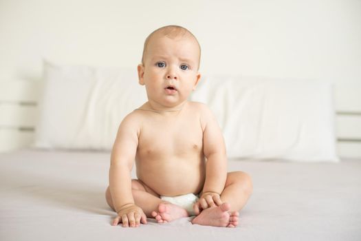 Portrait of a crawling baby on the bed in her room.