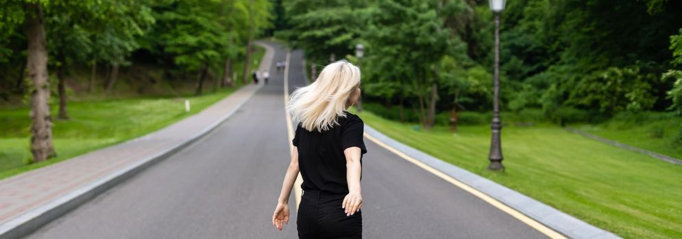 Woman walking along a country road.