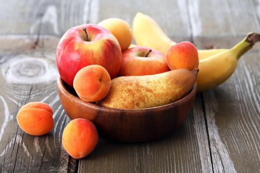 Heap of freshness fruits in  bowl on old wooden table