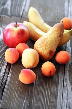 Heap of various freshness fruits on nice old wooden table