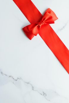 Holiday decor, feminine design and flatlay concept - Red silk ribbon on marble, top view