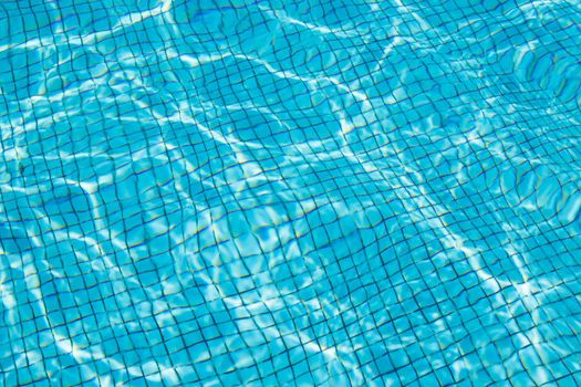 Hotel swimming pool with sunny reflections