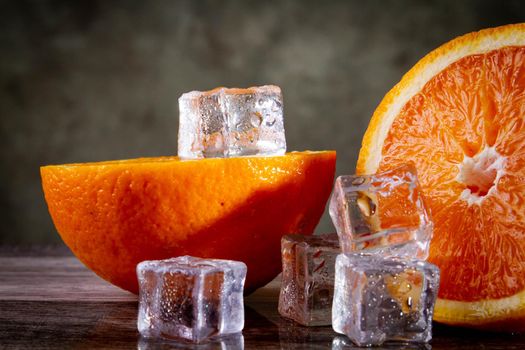 Orange and ice. Fresh ice juice. Fruity freshness of orange. Summer drink with orange juice ice.
