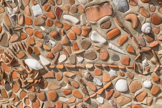 Concept of ancient culture Closeup photo of broken colored stones and sea shell with pearl mosaic background with glass and polish