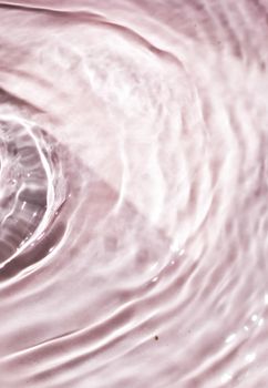 Pink flowing water texture as an abstract background - colourful liquids and creative designs concept. Pink flow