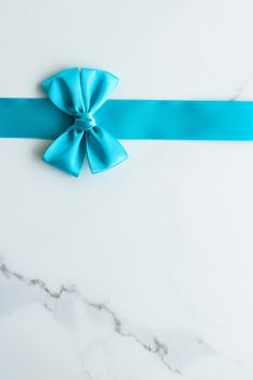 Holiday decor, feminine design and flatlay concept - Blue silk ribbon on marble, top view