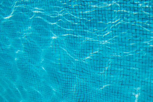 Hotel swimming pool with sunny reflections