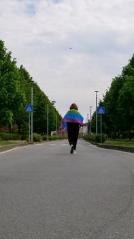 Bisexual, lesbian, female, transgender walk with LGBT flag on the road on a day and celebrate Bisexuality Day or National Coming Out Day