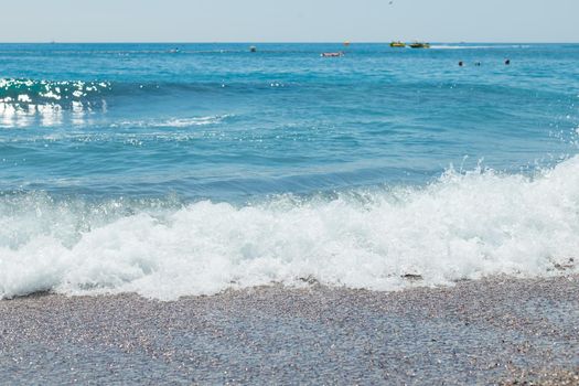 dark pebbles beach, blue sea and sky.Copy space