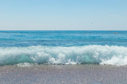 dark pebbles beach, blue sea and sky.Copy space
