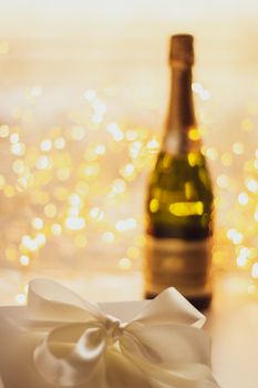 Romantic celebration, lifestyle and luxury present concept - The bottle of champagne and holiday gift box