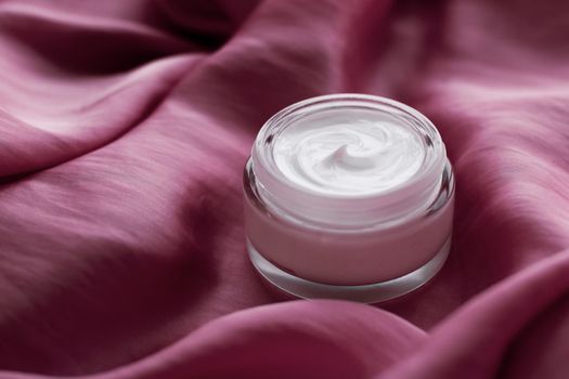 Beauty, anti-age cosmetics and skincare concept - Luxury face cream jar on a soft pink silk