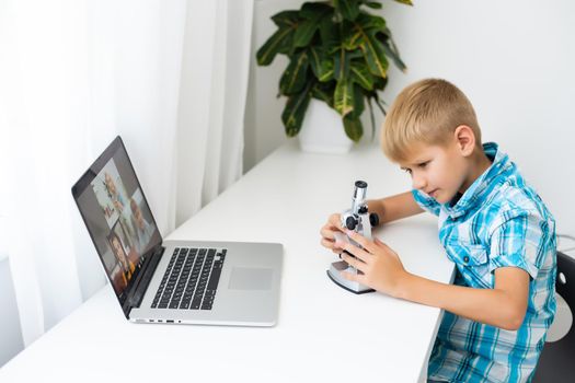 Children in classroom - work with microscope.