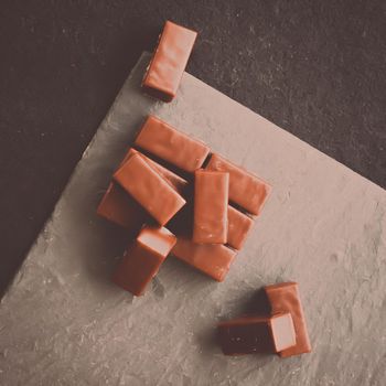 Sweet swiss chocolate candies on a stone tabletop, flatlay - desserts, confectionery and gluten-free organic food concept. All you need is chocolate