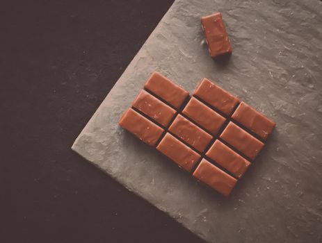 Sweet swiss chocolate candies on a stone tabletop, flatlay - desserts, confectionery and gluten-free organic food concept. All you need is chocolate