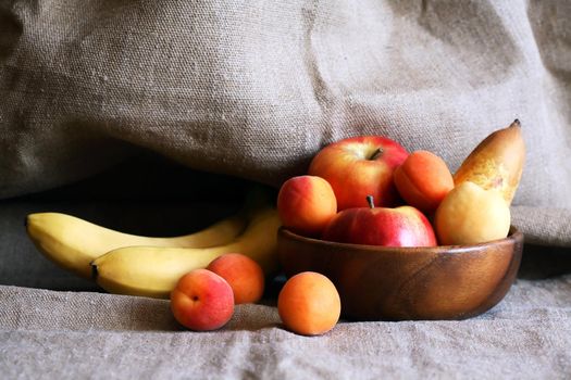 Heap of freshness fruits in  bowl againast nice gray canvas background