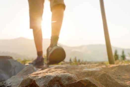 Hiking travel blurred walking travel hiking mountain walking hills. Close up feet hiking legs hiking trip nature walking pole. Blurred mountain adventure nature active travel mountain trekking pole