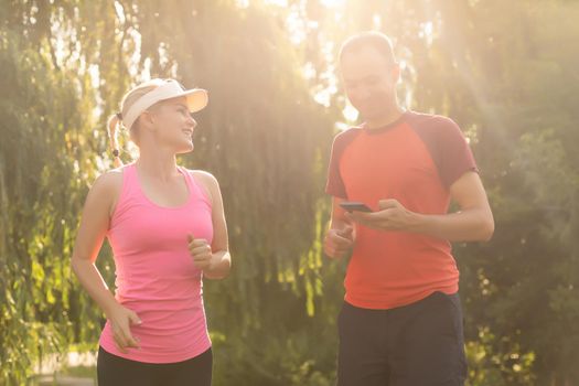 Urban sports - couple jogging for fitness in the city on a beautiful summer day.