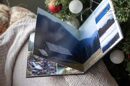 photo book about traveling near the Christmas tree.