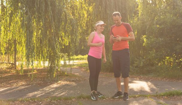 Urban sports - couple jogging for fitness in the city on a beautiful summer day.