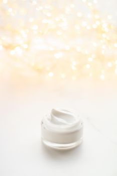 Beauty, anti-age cosmetics and skincare concept - Luxury face cream jar and holiday glitter