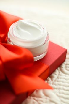 Beauty, cosmetics and skincare styled concept - Luxury face cream jar and red gift box