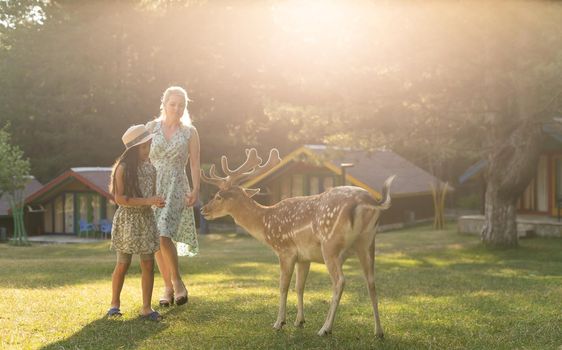 happy little girl with deer. family weekend.