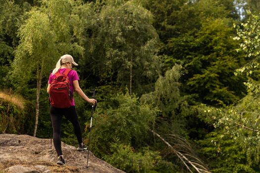 Girl Traveler hiking with backpack at rocky mountains landscape Travel Lifestyle concept adventure summer vacations outdoor