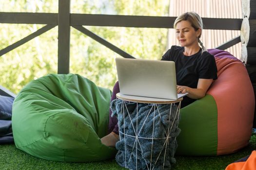 Work from home or study online, concept with a woman working at laptop outdoor on terrace.