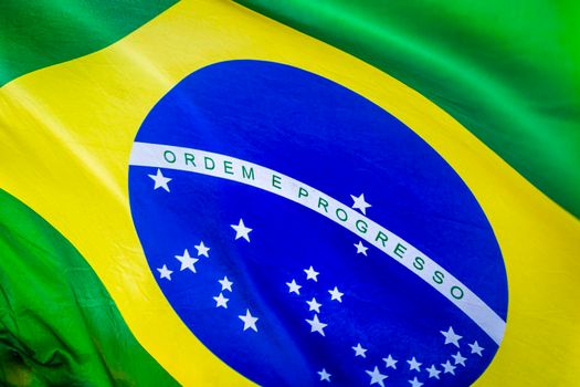 National flag of Brazil winding on blue sky in Brasilia, South America