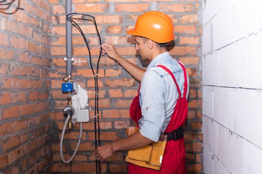 Young male worker or builder in building being renovated.