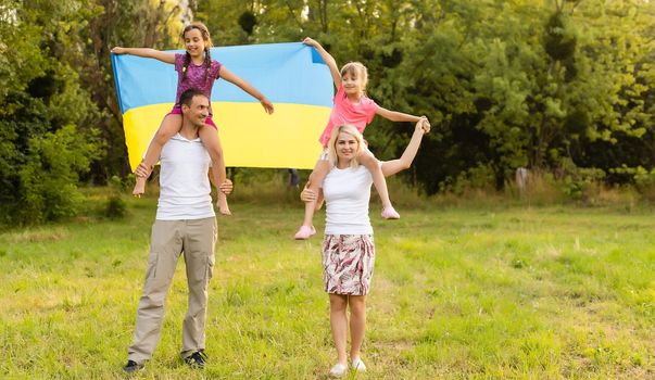 family with the flag of ukraine. Happy Independence Day of Ukraine. National Flag Day. Love for the homeland and symbols. Copy space