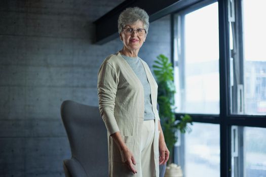 Close up portrait of beautiful senior woman posing at home