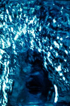 Abstract blue liquid surface as background - futuristic design and science concept. Deep blue waters