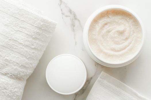 Scrub and exfoliating cream products on a marble, flatlay - skincare and body care, luxury spa and clean cosmetic concept. Health and beauty of your skin