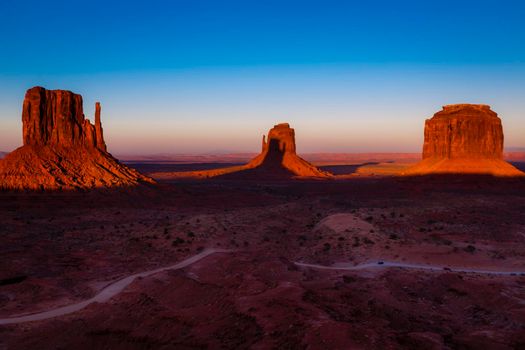 The Mittens, three buttes in Monument Valley at sunrise, Arizona and Utah, United States