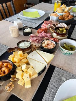 Dinner board with cheese, fruits and wine. Overhead of Cheeses and fruit served on a slate platter. . High quality photo
