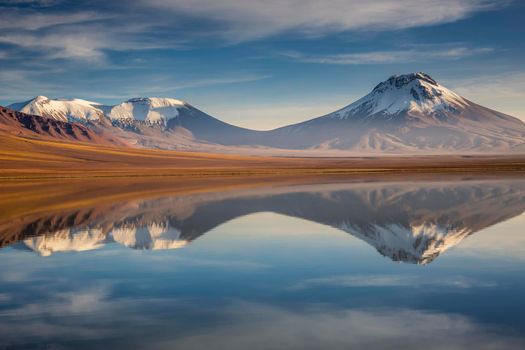 Idyllic Lake Lejia reflection and volcanic landscape in Atacama desert, Northern Chile, South America