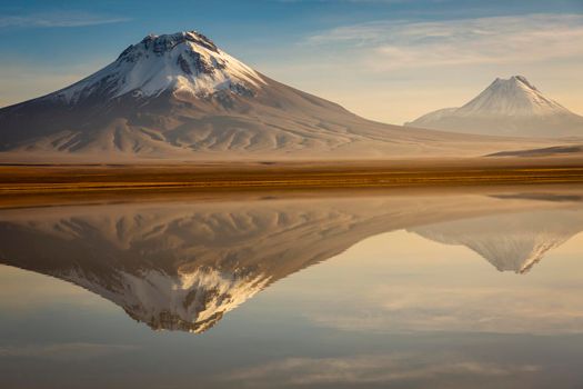 Idyllic Lake Lejia reflection and volcanic landscape in Atacama desert, Northern Chile, South America