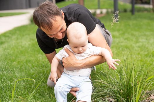 Summer portrait of beautiful baby on the lawn.