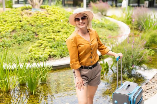 travel background, woman tourist walking with suitcase on the street in european city, tourism in Europe.