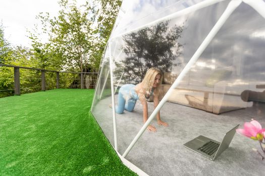 A woman is in a geo dome glamping tent. Glamping vacation lifestyle concept